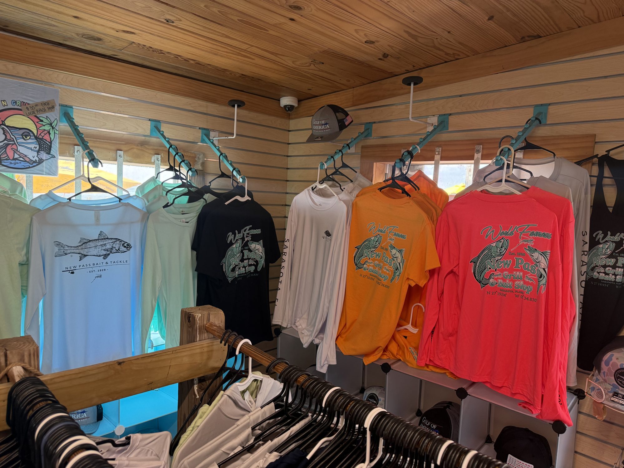 Racks of New Pass apparel and t-shirts inside the shop