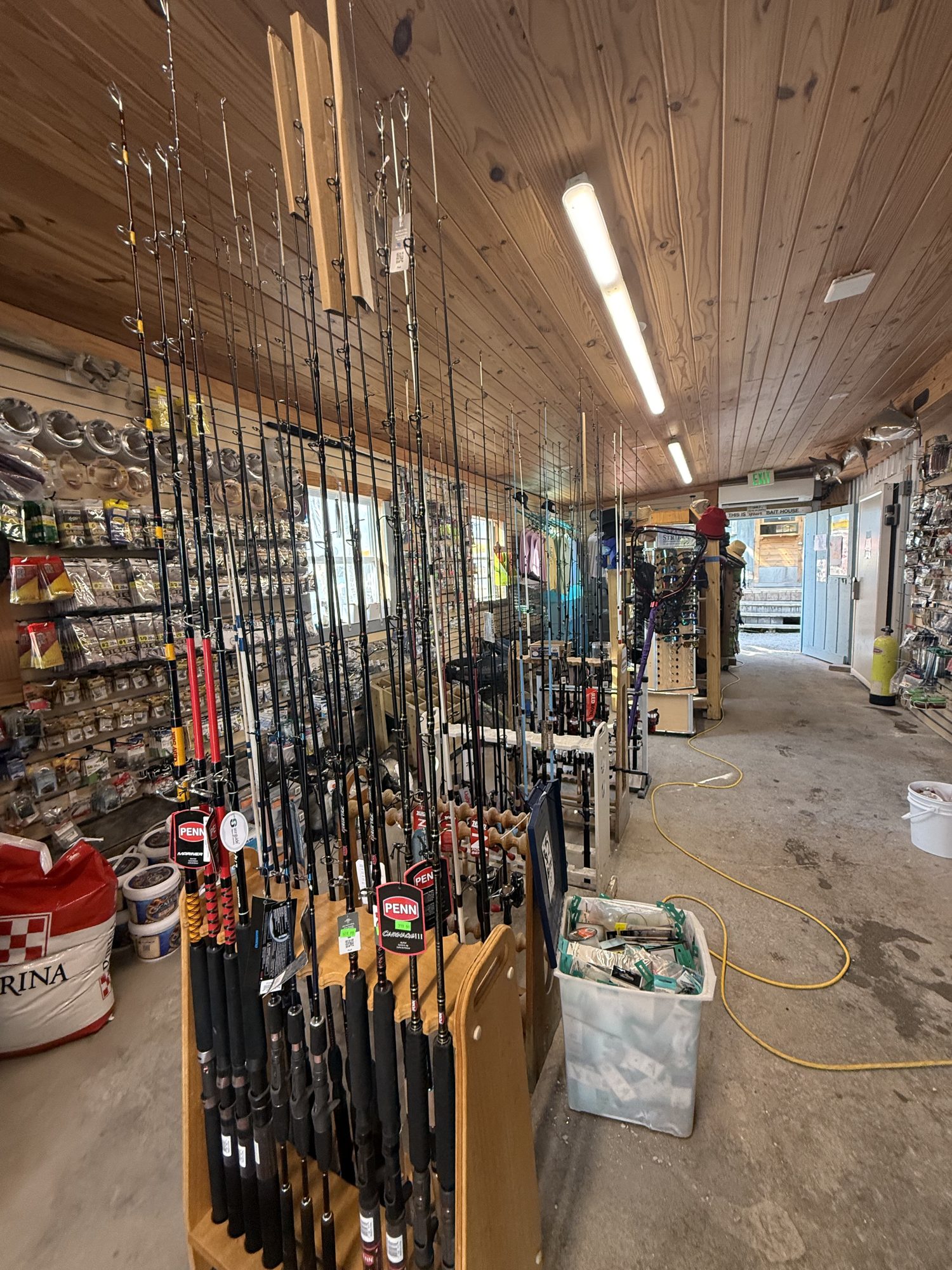 Wall of fishing rods and tackle inside the New Pass bait shop