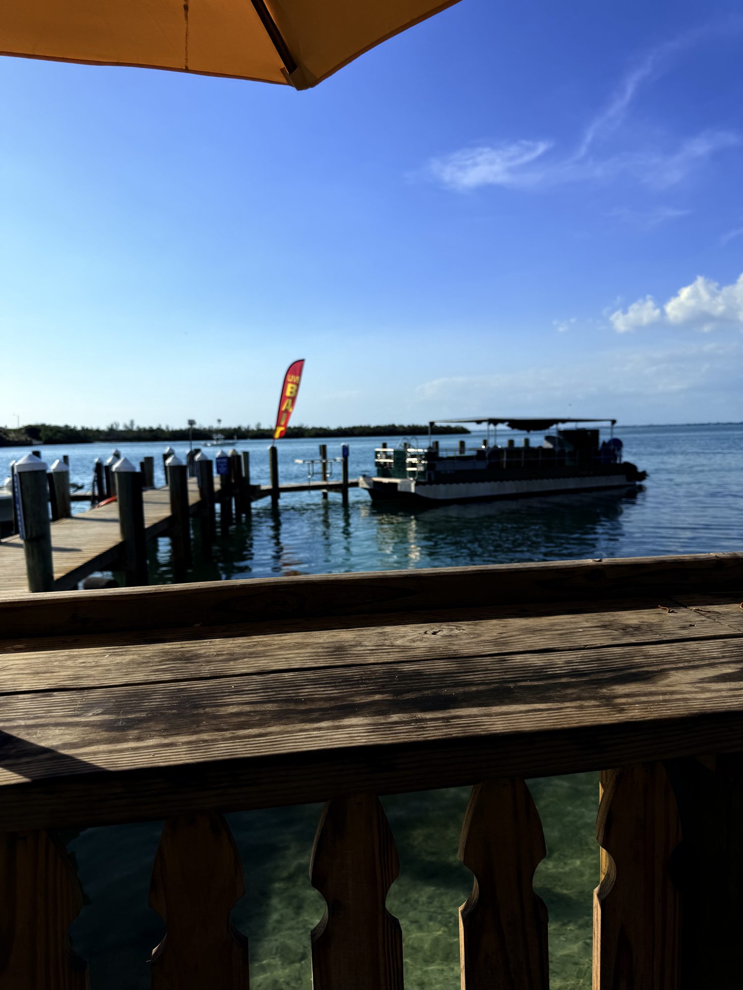 Charter and tiki boat tied up at the New Pass dock