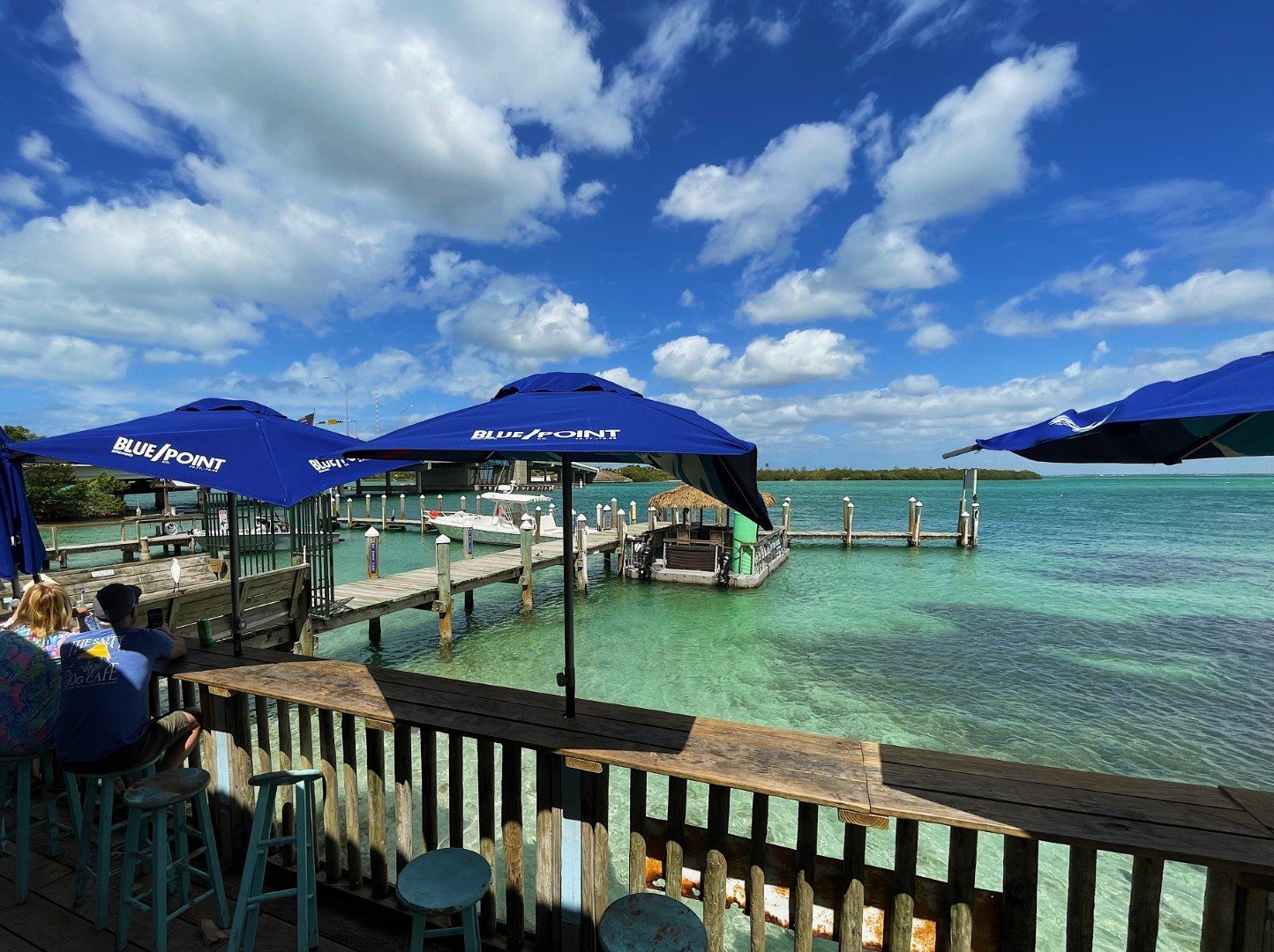 Boaters relaxing under umbrellas at the waterfront
