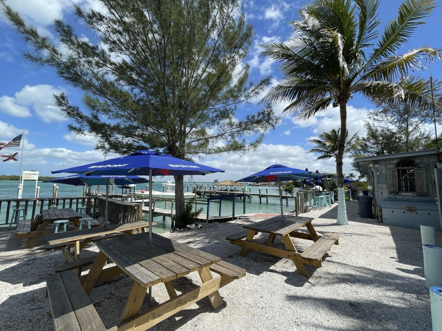 Dock and umbrellas over the teal water of New Pass