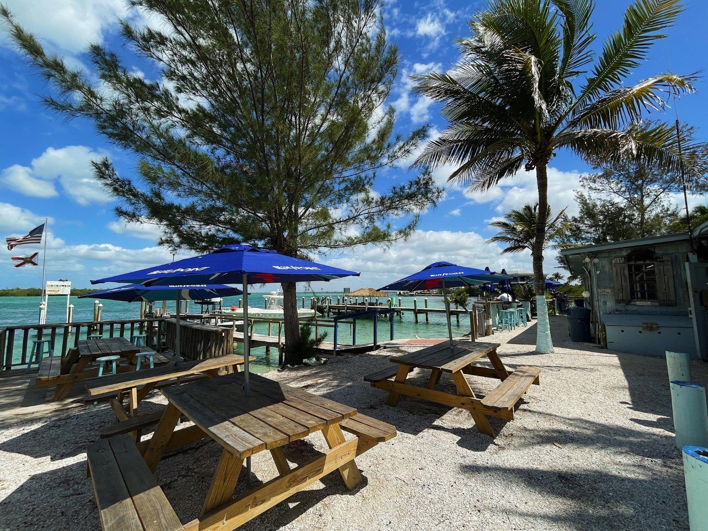 Umbrella-shaded dining deck over New Pass