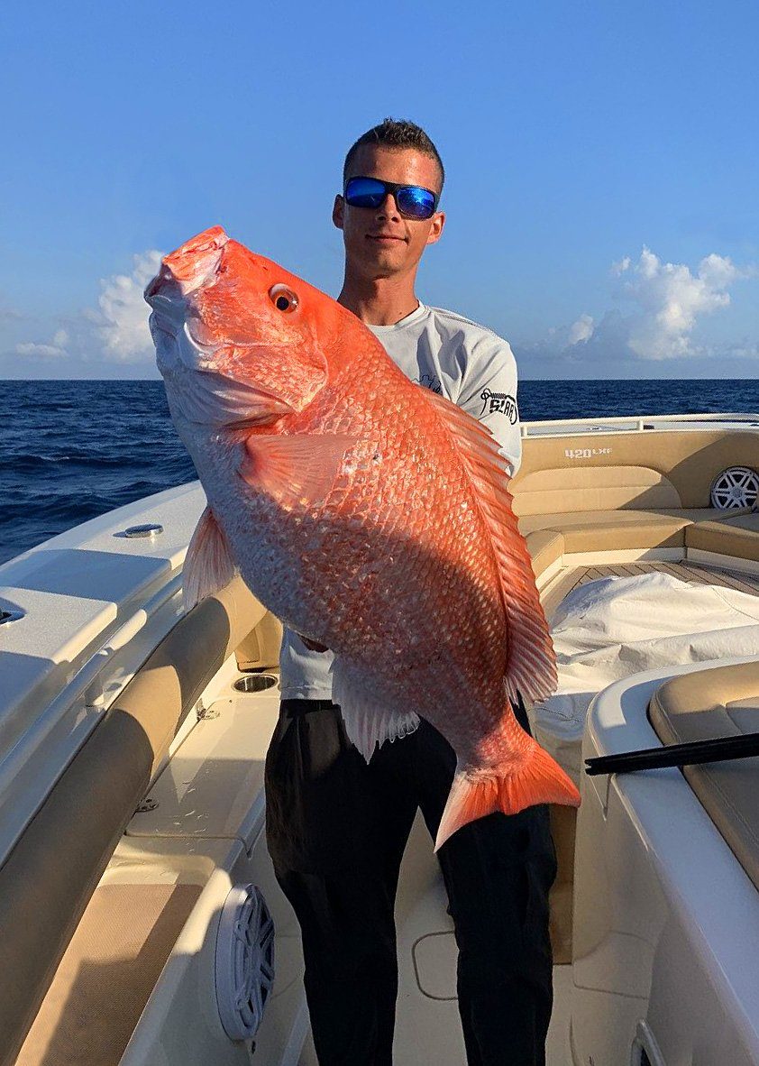 Angler holding up a freshly caught red snapper