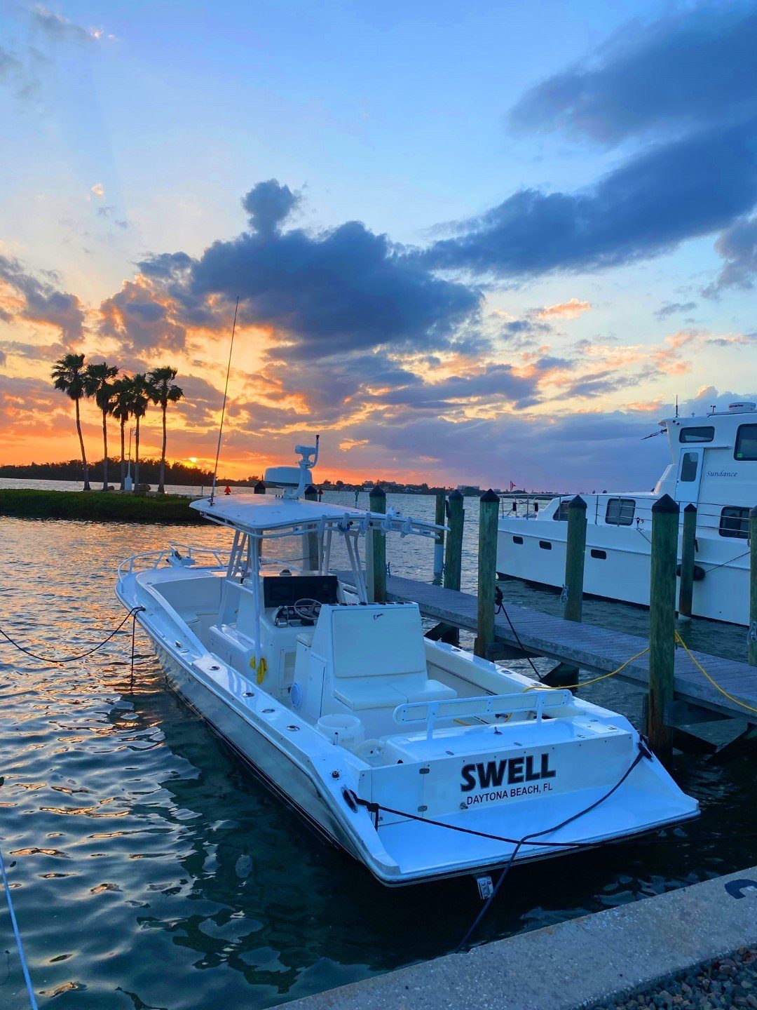 Charter boat heading out at sunset
